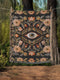 A luxury woven jacquard blanket in three sizes featuring an all-over wild herb botanical pattern of stylized blossoms and foliage in muted gold, olive, lavender, and pewter on a deep black cotton ground; finely twisted multicolor fringe edges complete the artful tapestry weave, ideal as a cozy sofa throw or dramatic wall hanging.